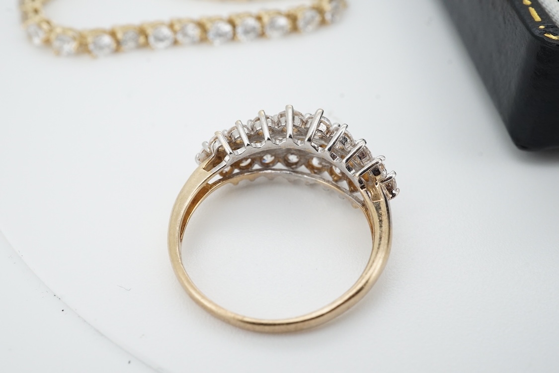 A modern yellow metal (stamped 585) and cubic zirconia set line bracelet, 18cm and a pair of similar drop earrings, together with a similar 9k and cubic zirconia set cluster ring, size N.